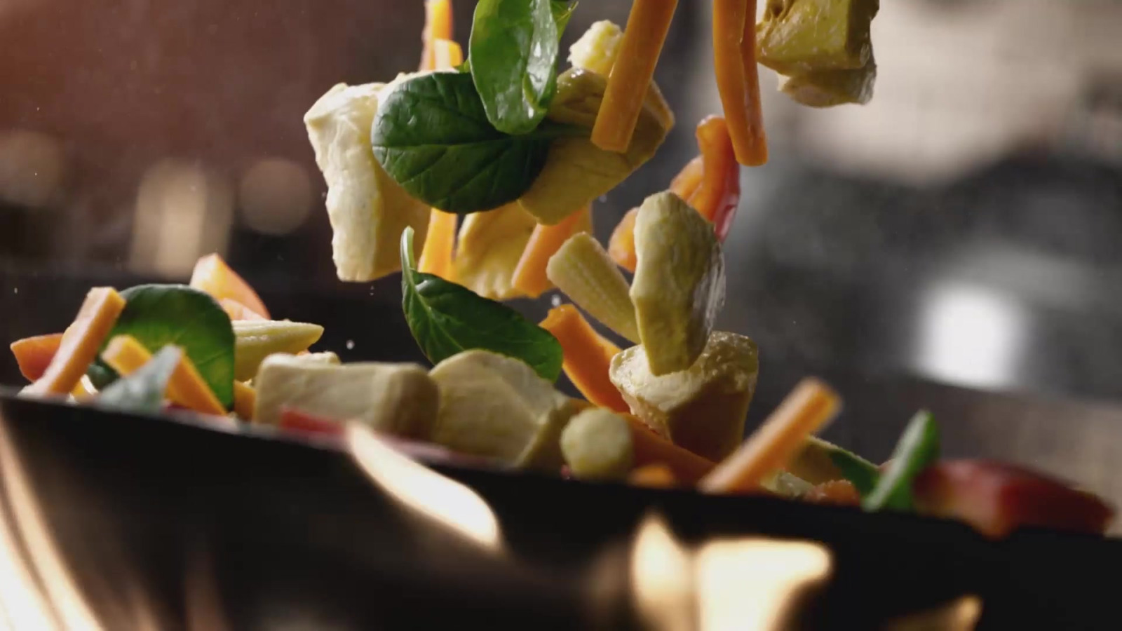 McDonald’s · Noodles – Fresh vegetables dropping into a wok and noodles being tossed