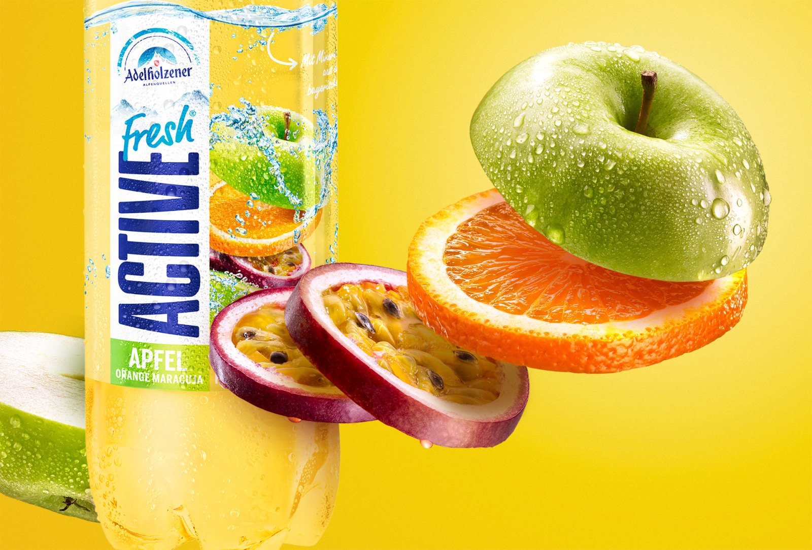 Adelholzener Active Fresh bottle with a green apple, orange slices and passion fruit against a yellow background.